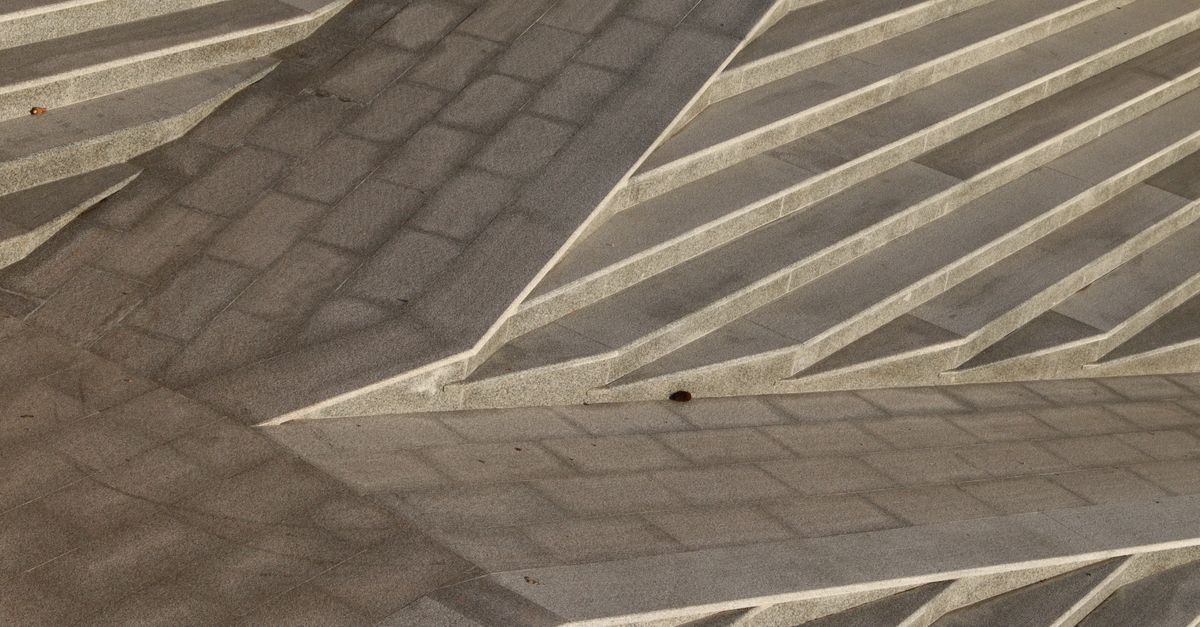 Detailed abstract view of concrete stairs with intricate geometric patterns and shadows.