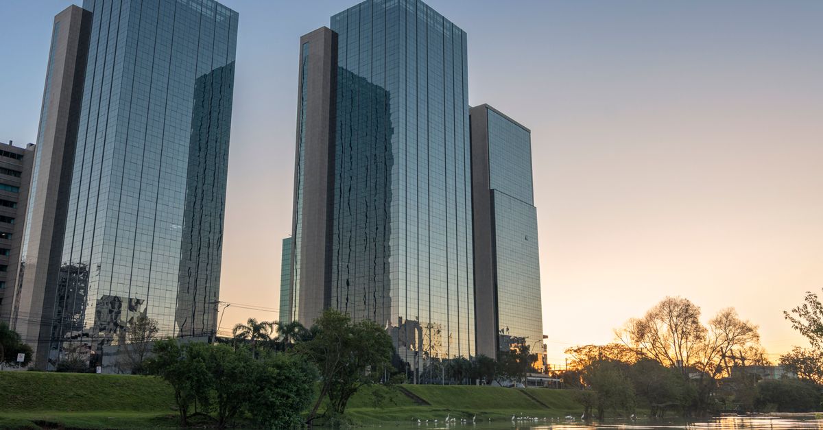 Stunning skyscrapers with glass facades reflecting water and sunset in Rio Grande do Sul, Brazil.