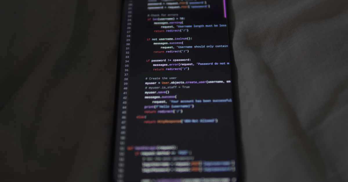 Close-up of a smartphone showing Python code on the display, showcasing coding and technology.