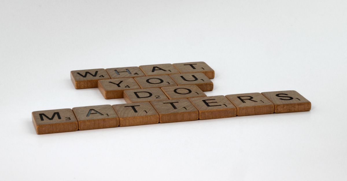 Scrabble tiles form the motivational phrase 'What You Do Matters' on a white background.