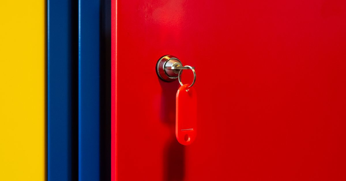 A vibrant image of a red locker door with a key in the lock, featuring bold primary colors.