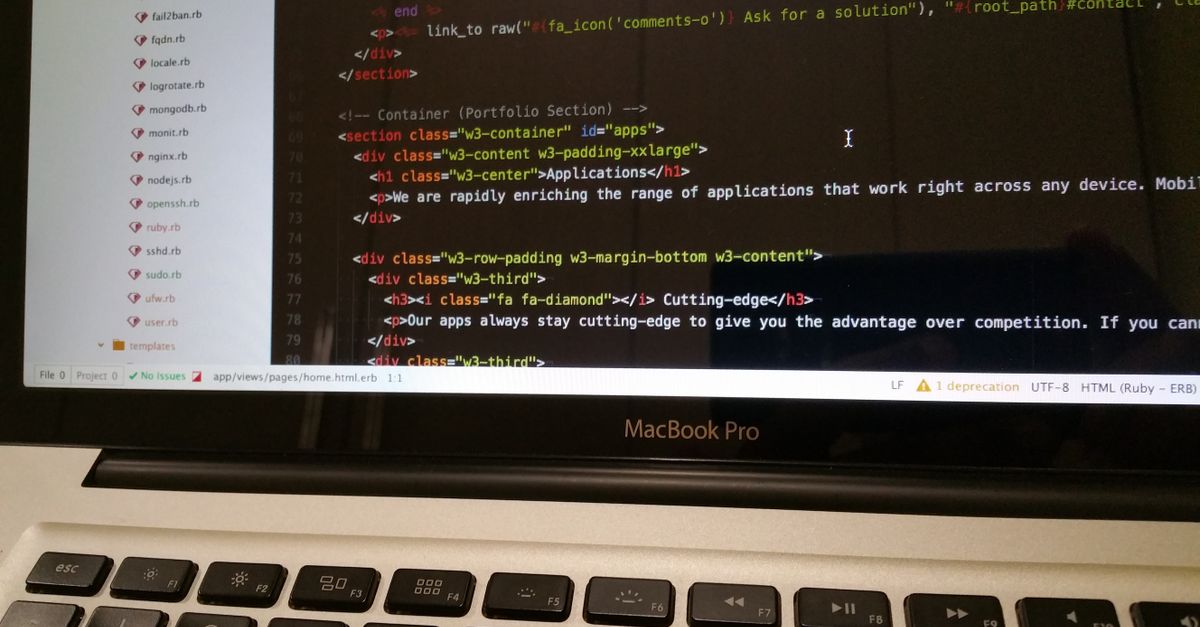 Close-up of HTML code displayed on a MacBook Pro screen, showcasing modern web development.