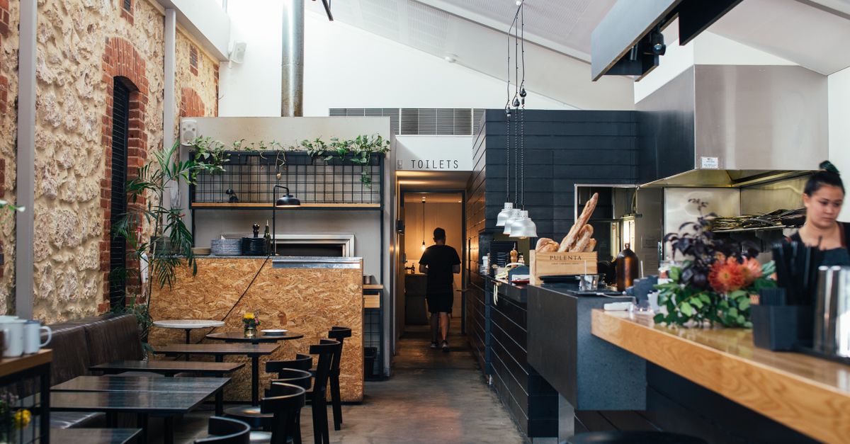 Contemporary restaurant with comfortable interior with chairs and tables near counter in daytime