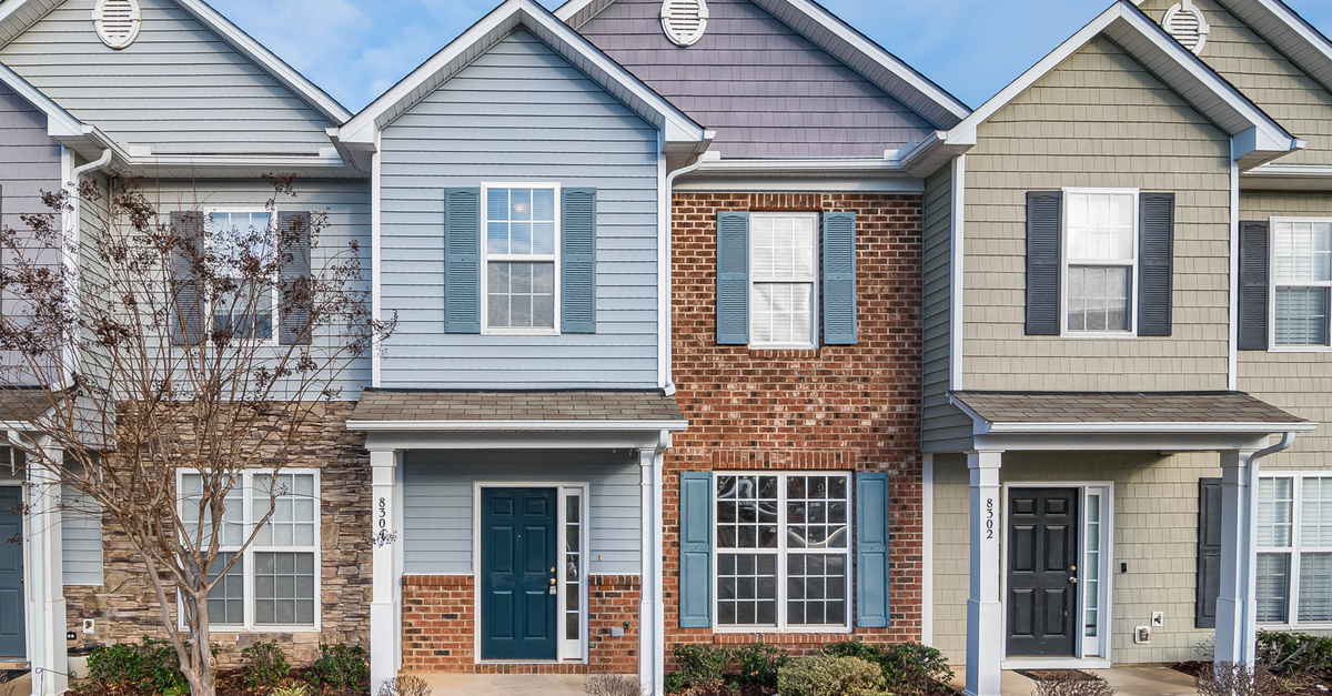 Elegant view of suburban townhouses showcasing diverse architectural styles.