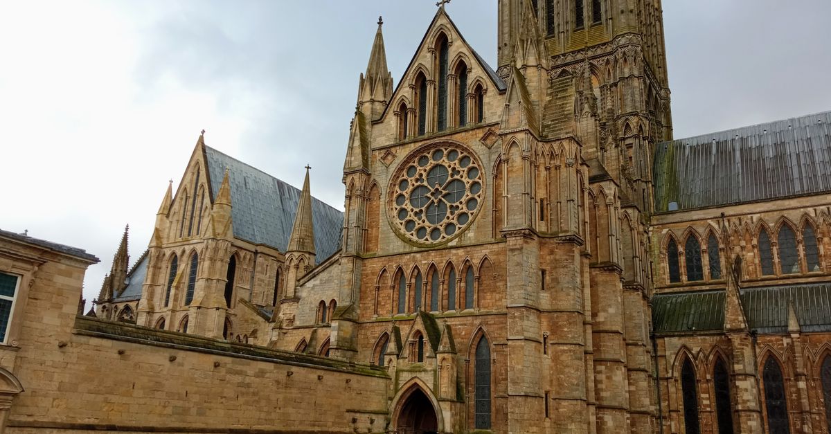 Explore the stunning Gothic architecture of Lincoln Cathedral in England under an overcast sky.