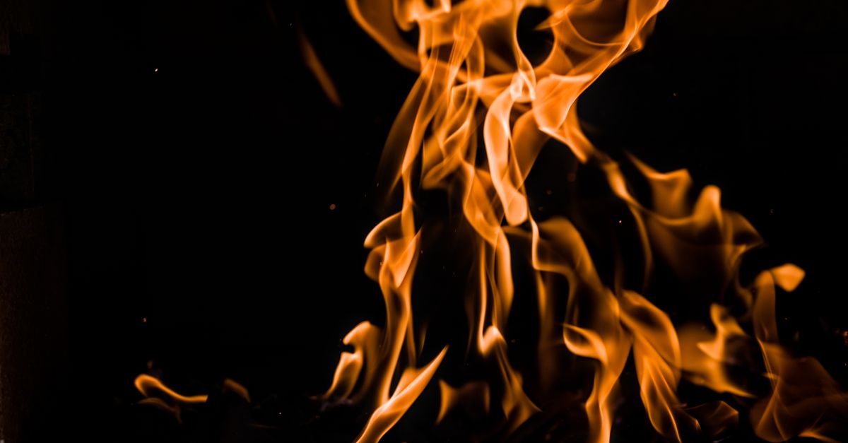 Dramatic close-up of orange flames against a dark background, highlighting fire dynamics.