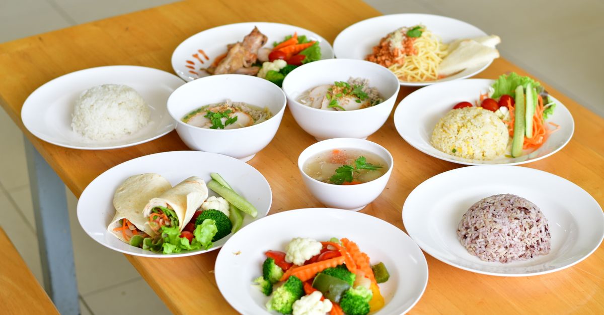 A variety of nutritious dishes displayed on a wooden table, showcasing diverse healthy meals.