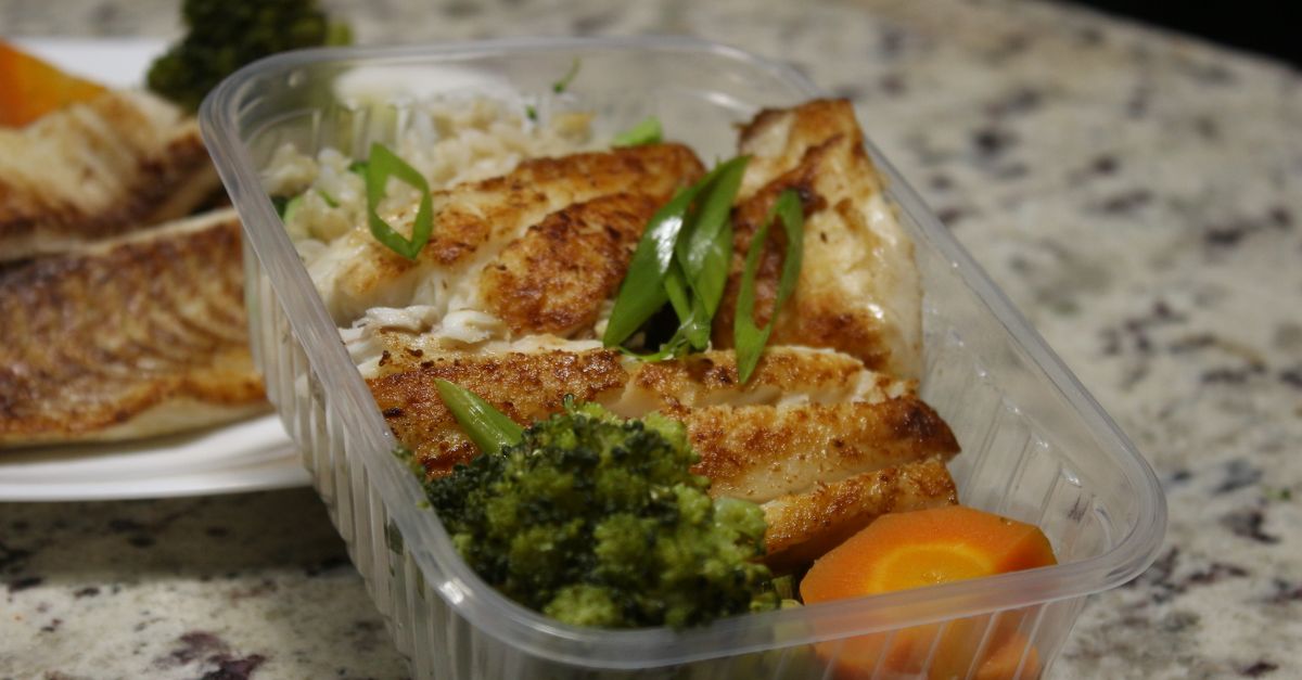 Delicious grilled chicken with broccoli and carrots in a meal prep container. Perfect for healthy eating.