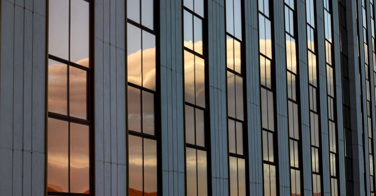 Glass building windows reflecting a stunning sunset in Reno, NV.