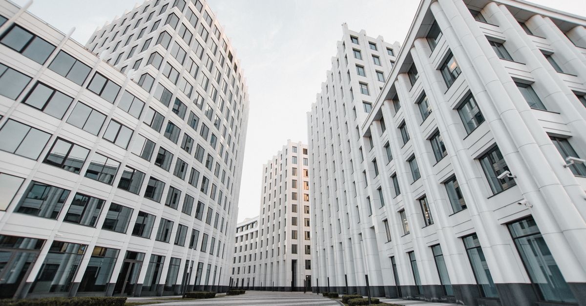 View of tall modern white buildings with glass windows forming a distinctive architectural style.