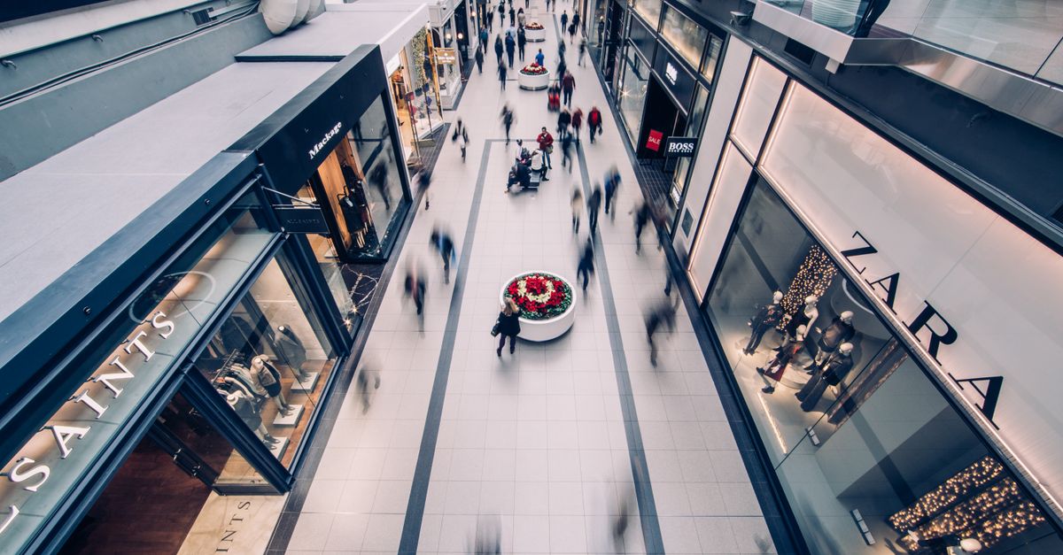 A vibrant scene capturing a busy shopping mall with modern stores and diverse shoppers on the move.