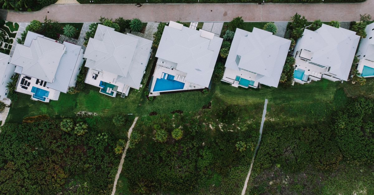 Aerial shot showcasing modern homes with pools in Fort Pierce, Florida neighborhood.