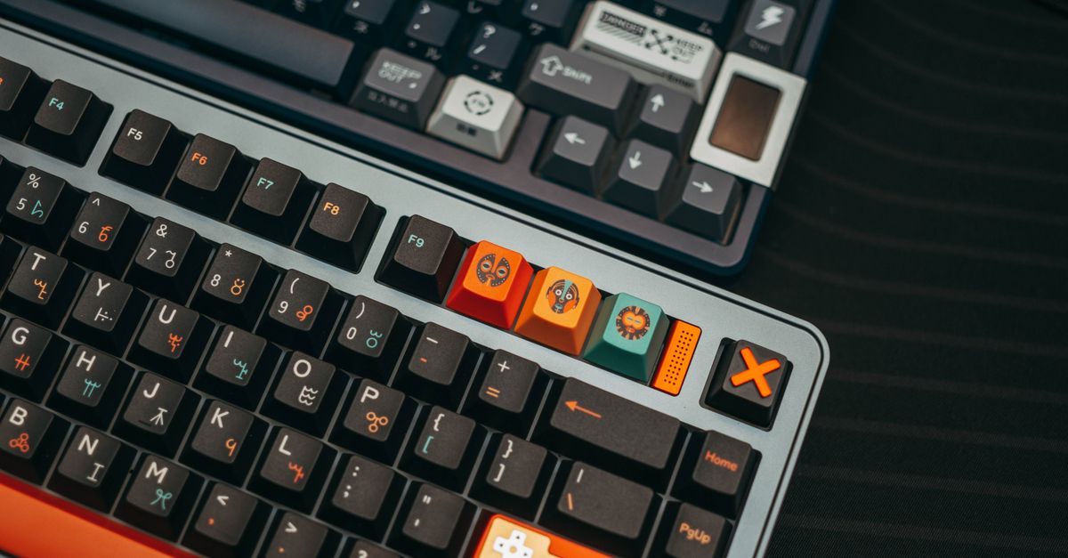 Detailed close-up of two custom mechanical keyboards with colorful keycaps and unique designs.