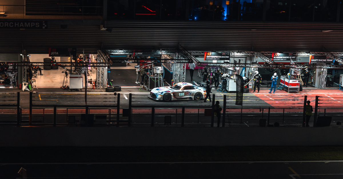 A sports car in a pit stop at night during a race at Spa-Francorchamps, Belgium.