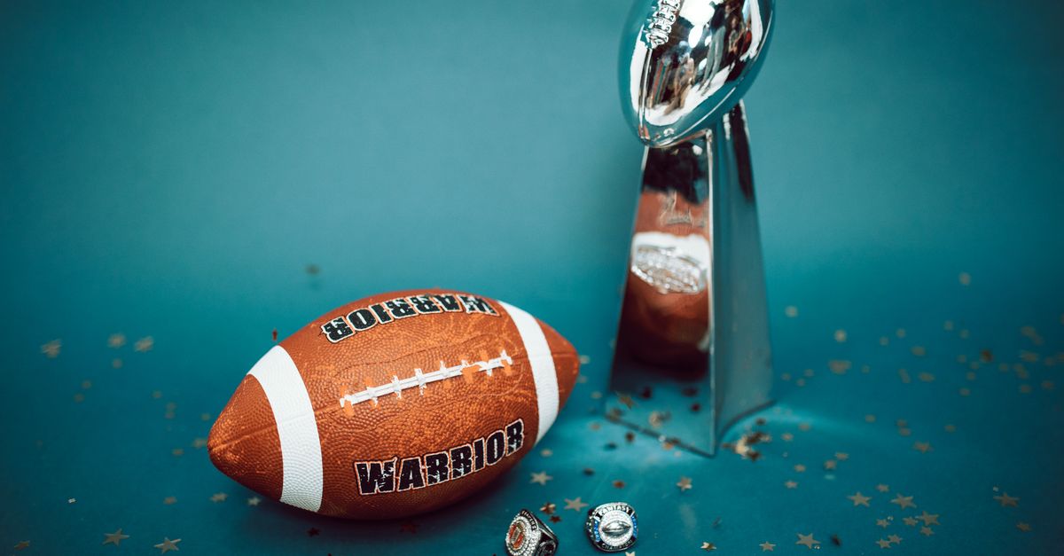 Football and trophy with championship rings on a celebratory background.