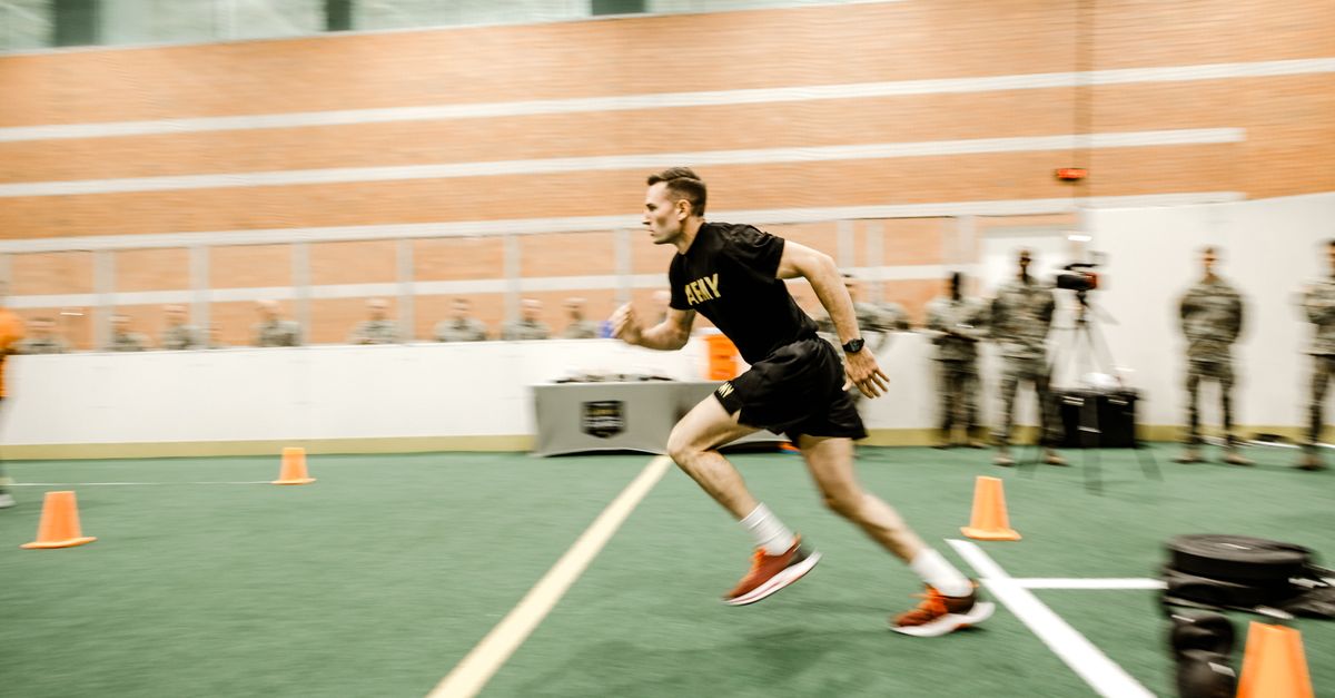 Captivating shot of an army soldier sprinting during fitness test indoors.