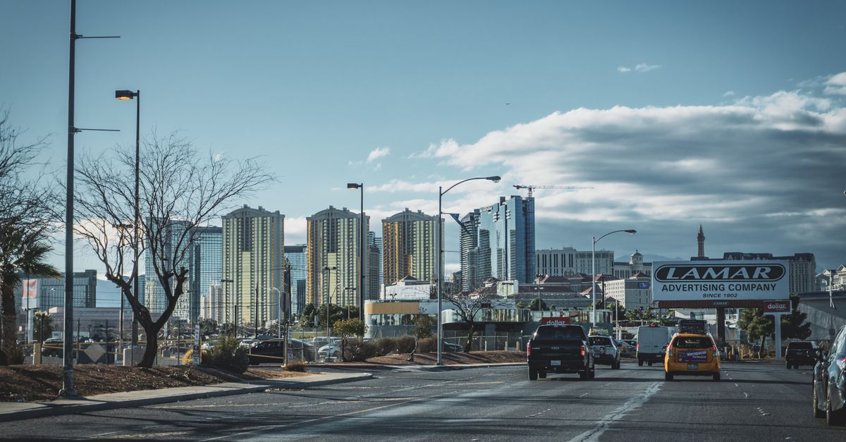 Dynamic view of Las Vegas skyline with bustling street traffic and modern skyscrapers.