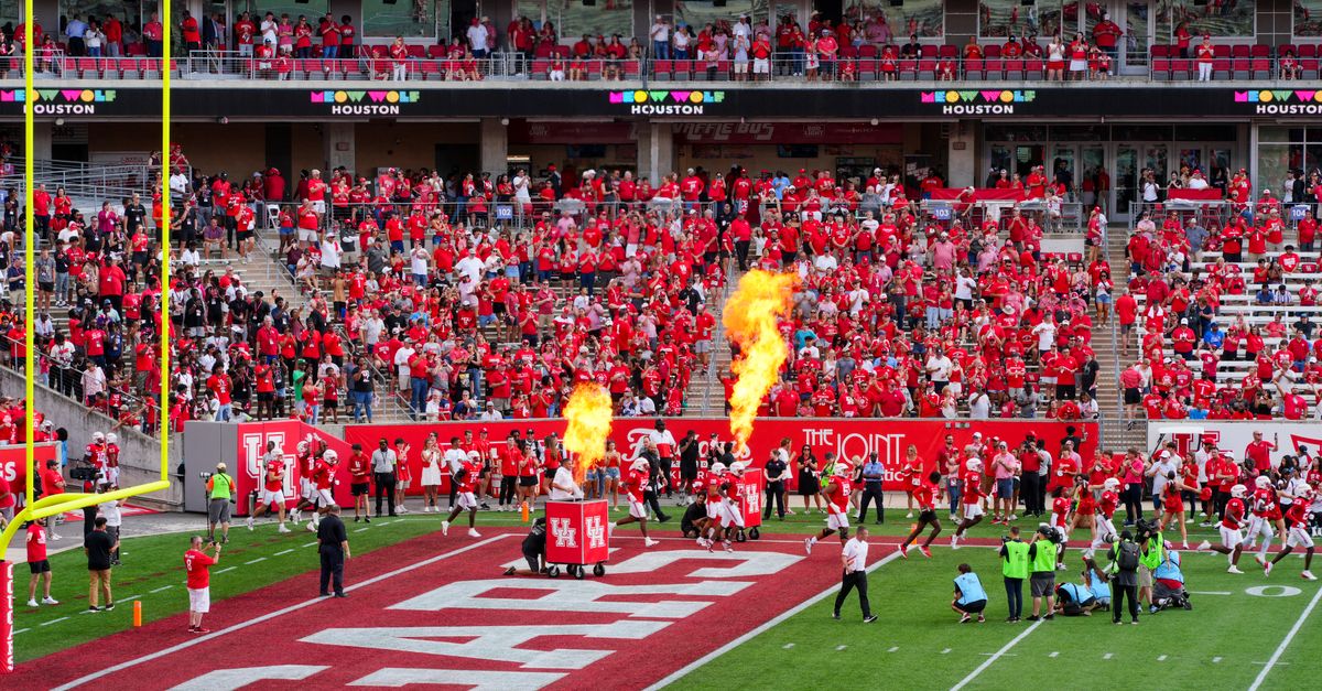 Houston college football match with vibrant crowd and fire effects. Captures the sports spirit.