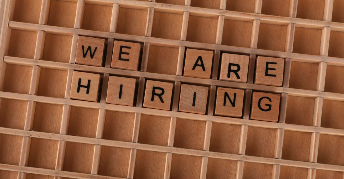 Wooden tiles on a board forming the phrase 'We Are Hiring', ideal for job announcements.
