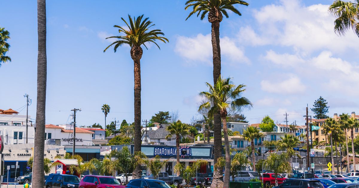 Experience the lively atmosphere of Santa Cruz Beach Boardwalk on a sunny day.
