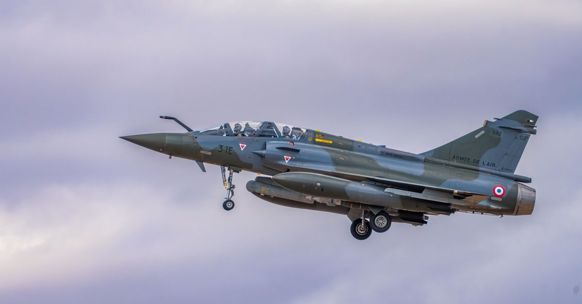 Dassault Mirage 2000 fighter jet flying with landing gear deployed.
