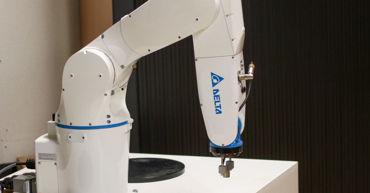Close-up of a Delta brand robotic arm in an industrial setting, showcasing automation technology.