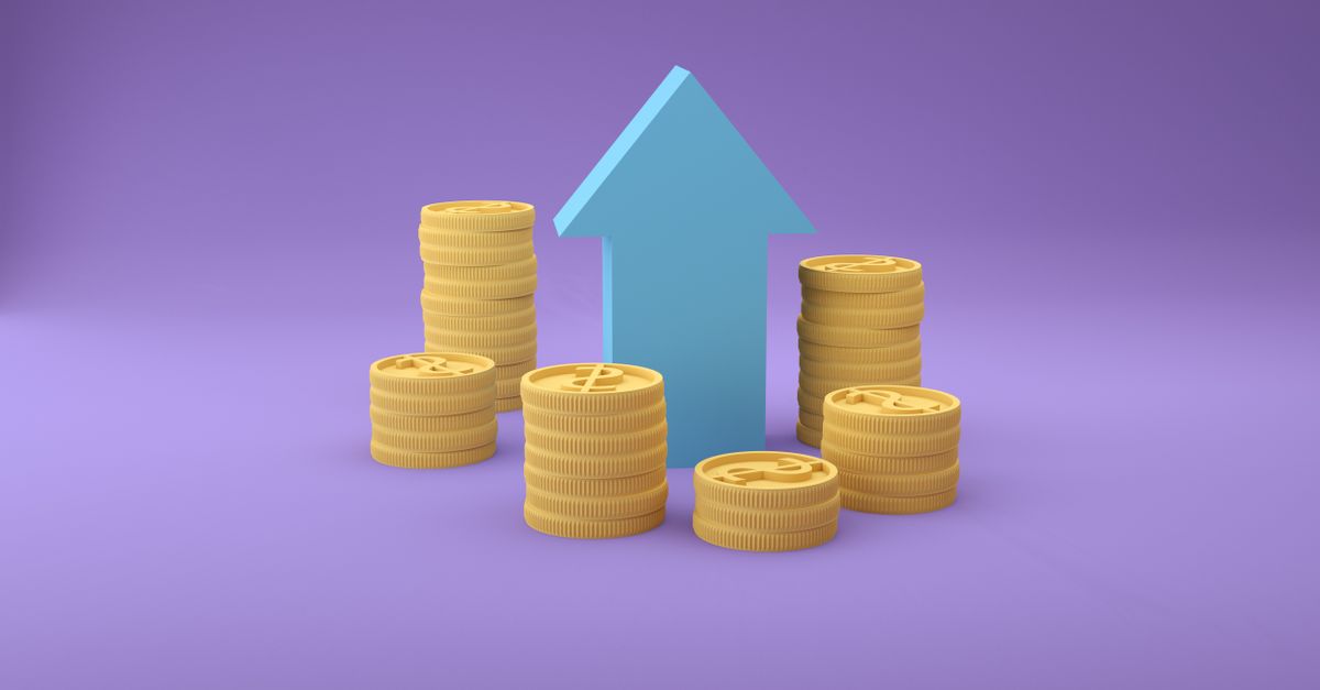 Stacks of coins with an upward arrow symbolizing financial growth and success.