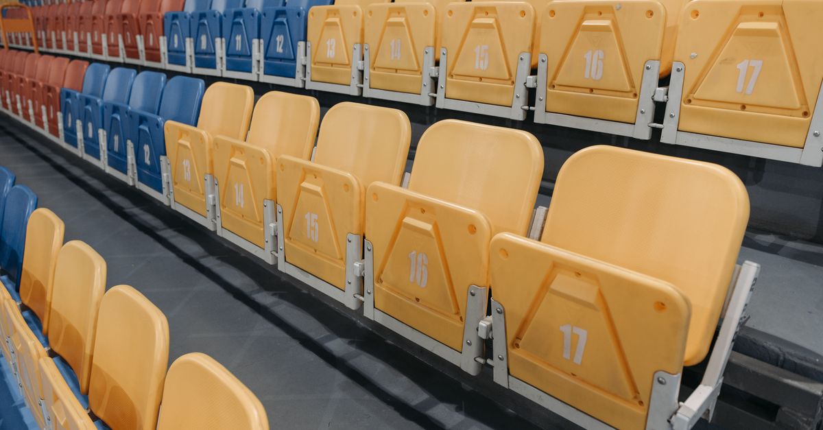 Colorful empty seats in a stadium bleachers perfect for sports events and concerts.