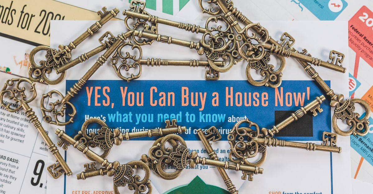 Vintage keys spread over real estate documents symbolizing property ownership and investment.
