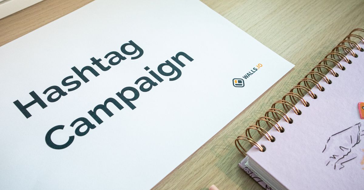 A clean office desk setup featuring hashtag campaign marketing materials and a planner.