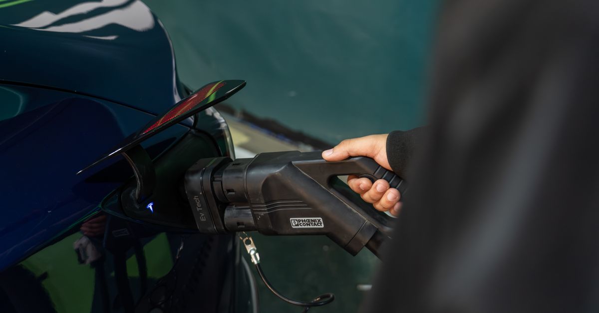 Close-up of an electric vehicle being charged at a station.