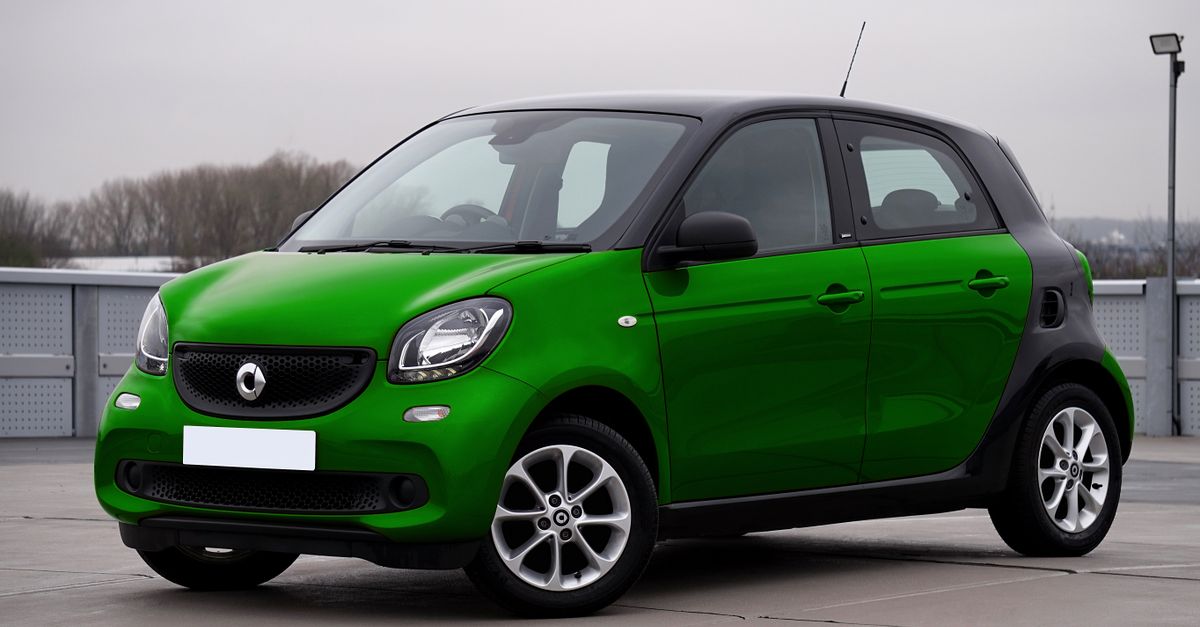 A green compact urban car parked outdoors, perfect for city driving. Modern and stylish design.