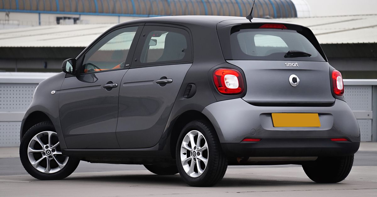 Gray Smart Forfour viewed from behind in a modern urban environment.