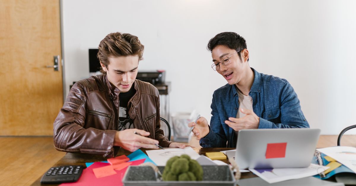 Two business professionals discuss ideas and strategies in an office setting, fostering innovation and teamwork.