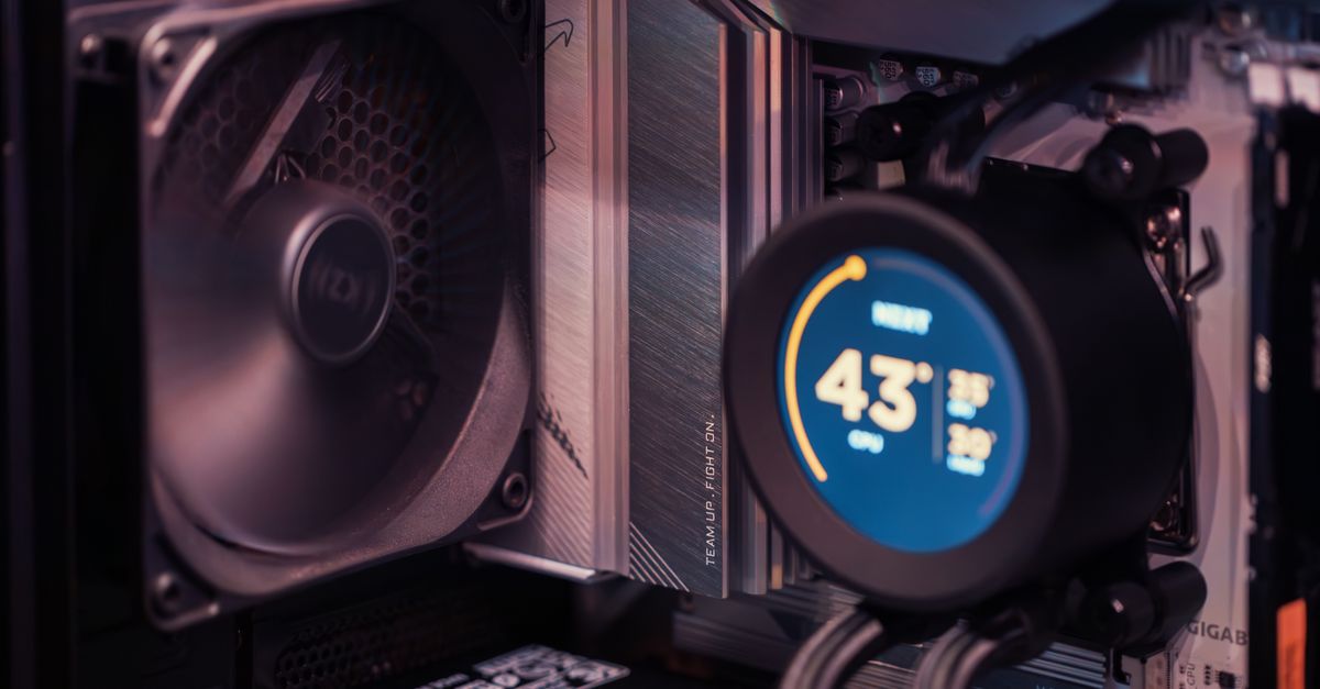 Close-up of a gaming PC build showcasing GPU, fan, and liquid cooling system.