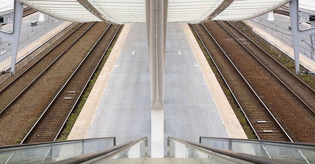 View from an escalator of a modern railway station showcasing symmetrical design.