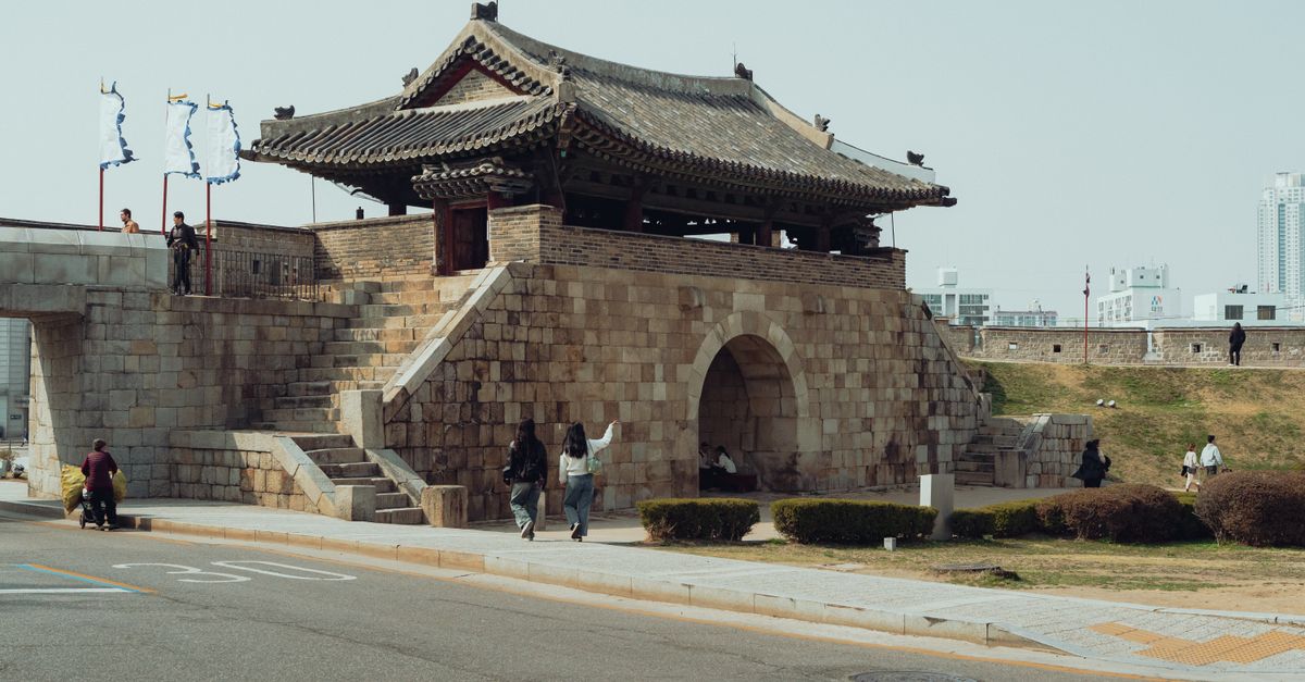 Explore the ancient Hwaseong Fortress gate in Suwon, Korea, showcasing traditional architecture.