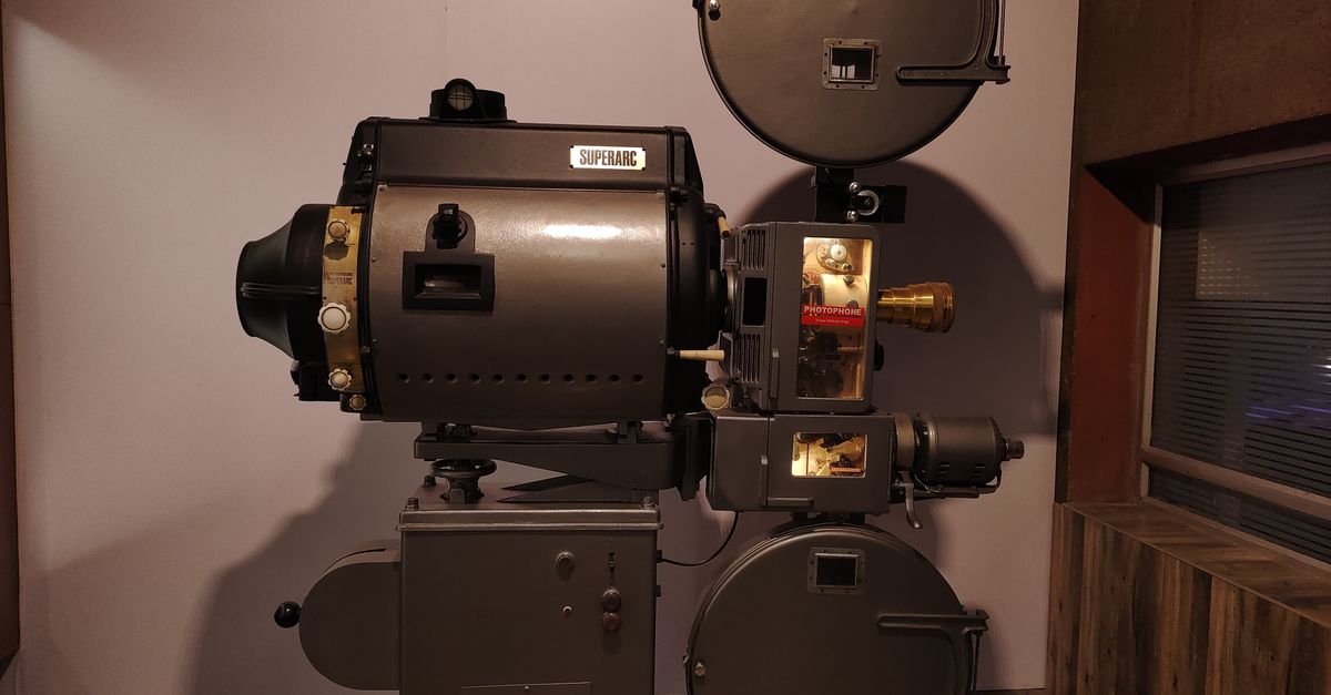 Old-fashioned Superarc film projector displayed indoors, evoking cinematic history.