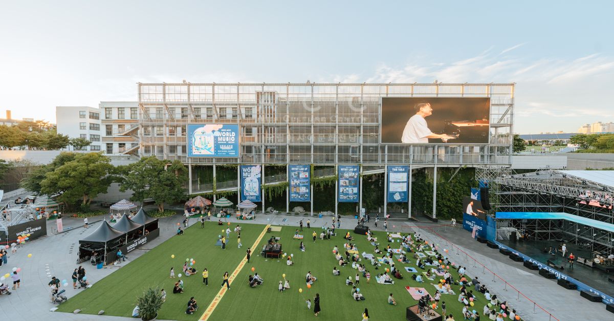 A vibrant outdoor concert at the Asia Culture Center plaza with an audience enjoying sunset views.