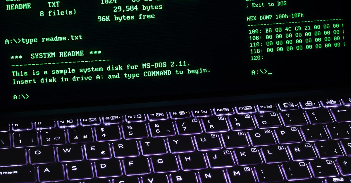 A classic MS-DOS terminal screen displayed on a laptop keyboard with vivid illumination.