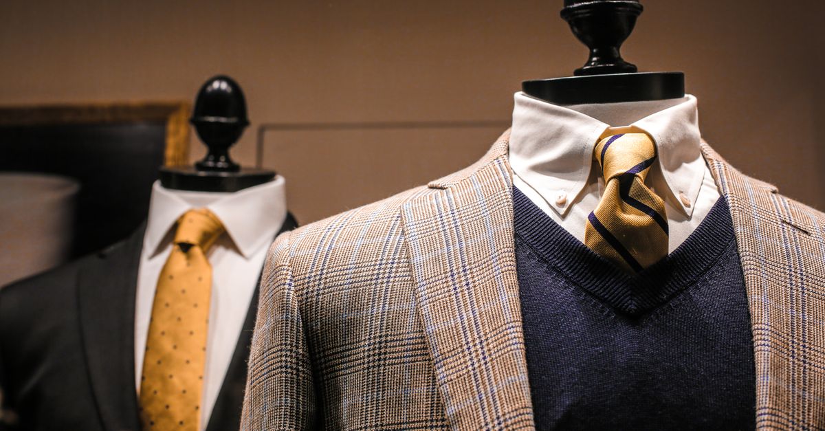 Dandy fancy jackets with shiny ties on dummies in showroom of contemporary male shop