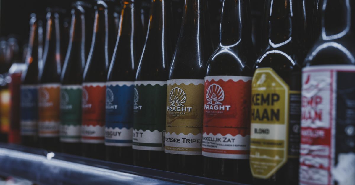 A selection of colorful craft beer bottles displayed on a shelf in a store in Almere, Netherlands.