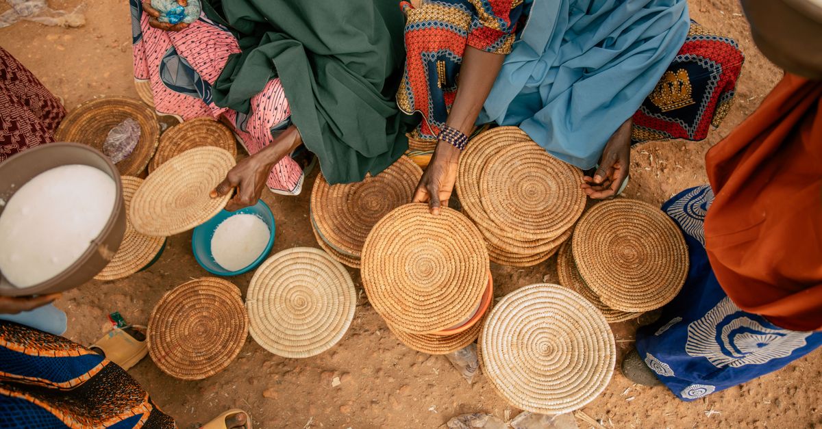 Women crafting and selling handmade baskets in Daura, Nigeria.