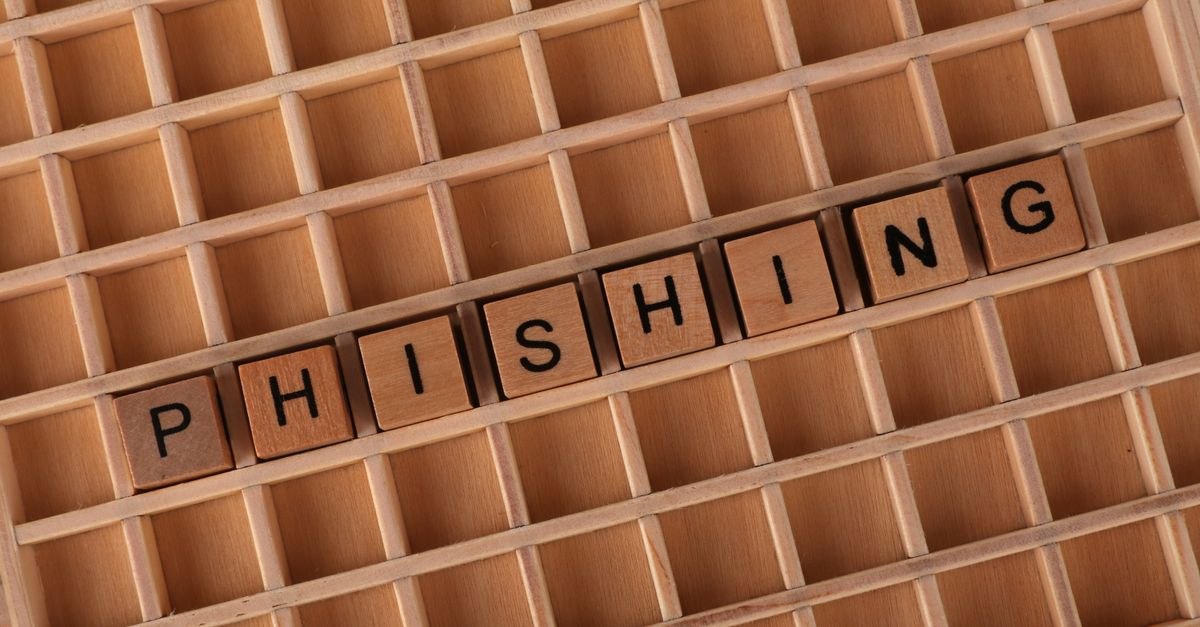 Wooden Scrabble tiles arranged to spell 'Phishing', illustrating online security concepts.