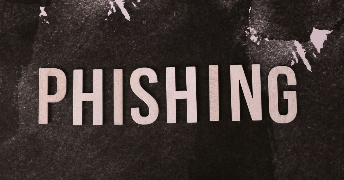 Abstract representation of phishing with the text on a textured dark surface.