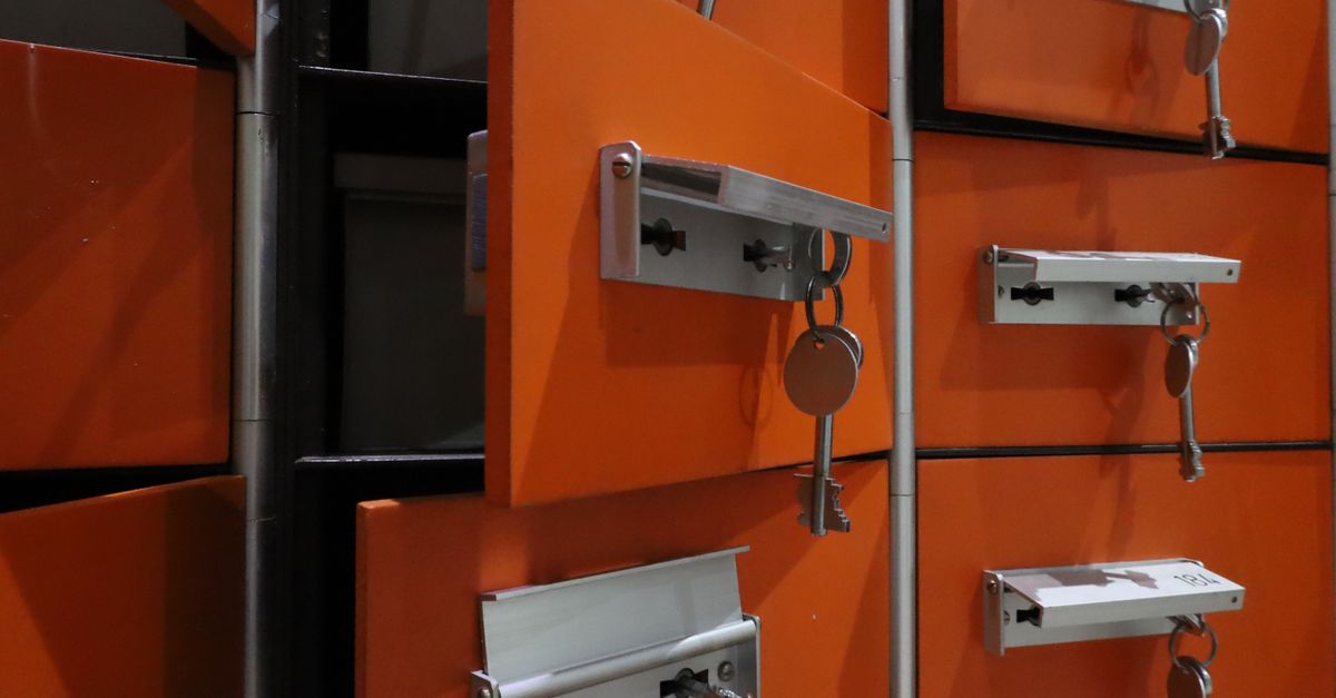 Orange lockers with metal keys highlighted in an indoor setting.