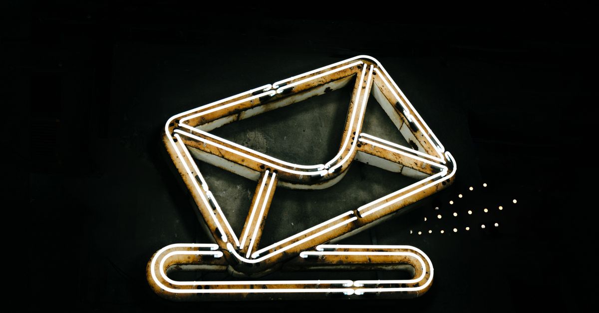 A glowing neon envelope symbol against a black background, conveying messaging or email concept.