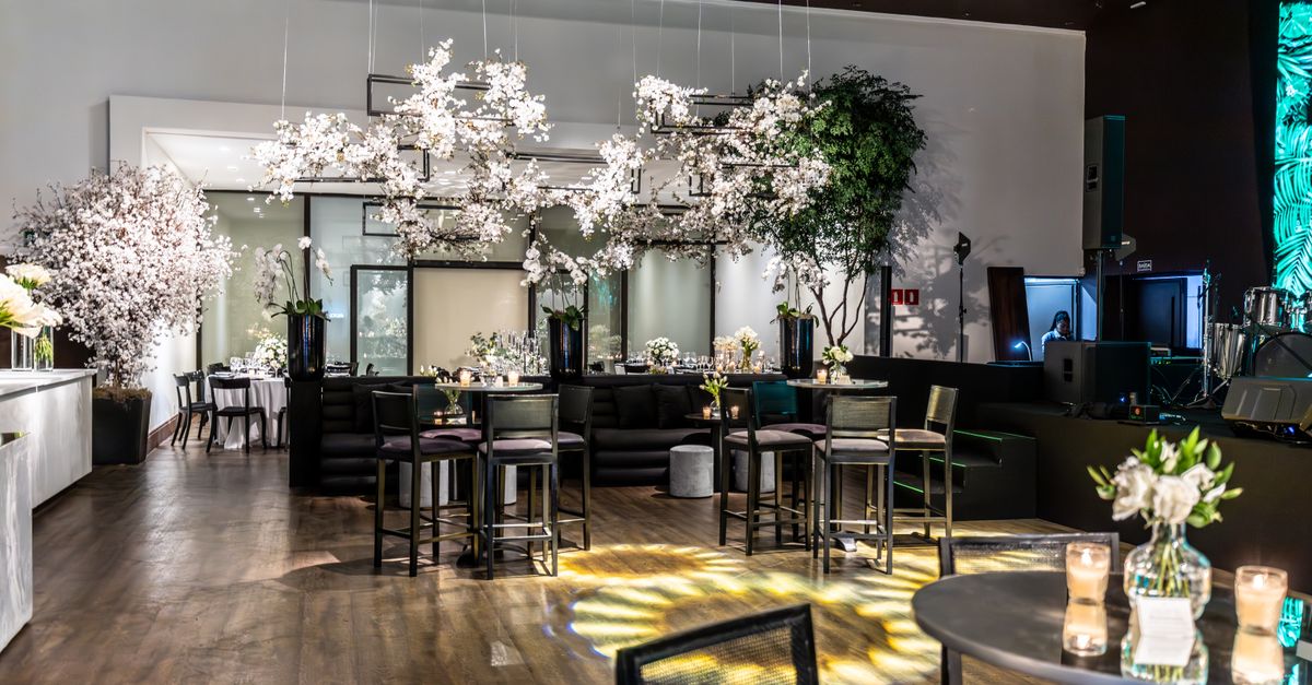 Luxurious banquet hall interior with floral decorations and elegant furniture setup, perfect for weddings or events.
