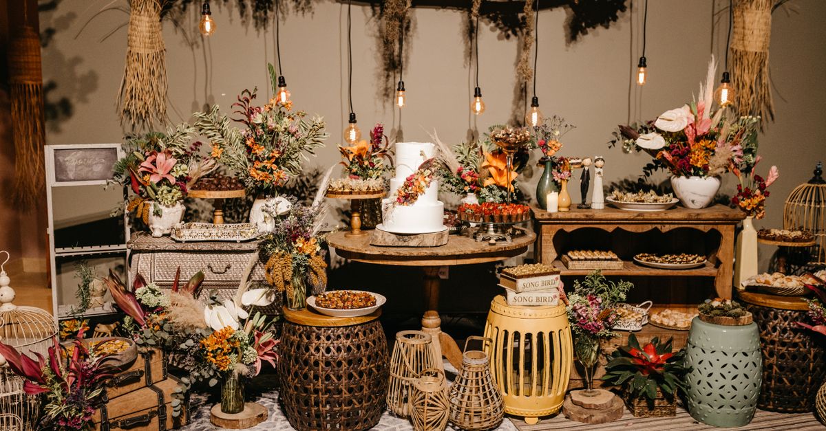Charming rustic wedding reception with flowers, cake, and vintage decor beautifully arranged.