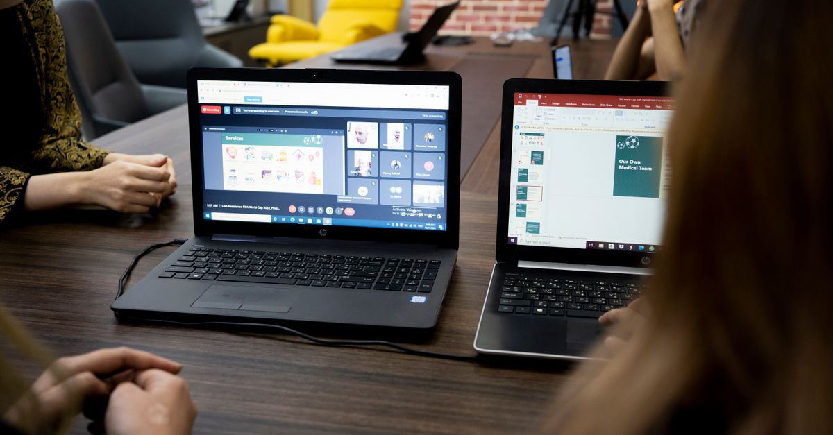 Team discusses projects during a virtual and in-person meeting in a Dubai office.